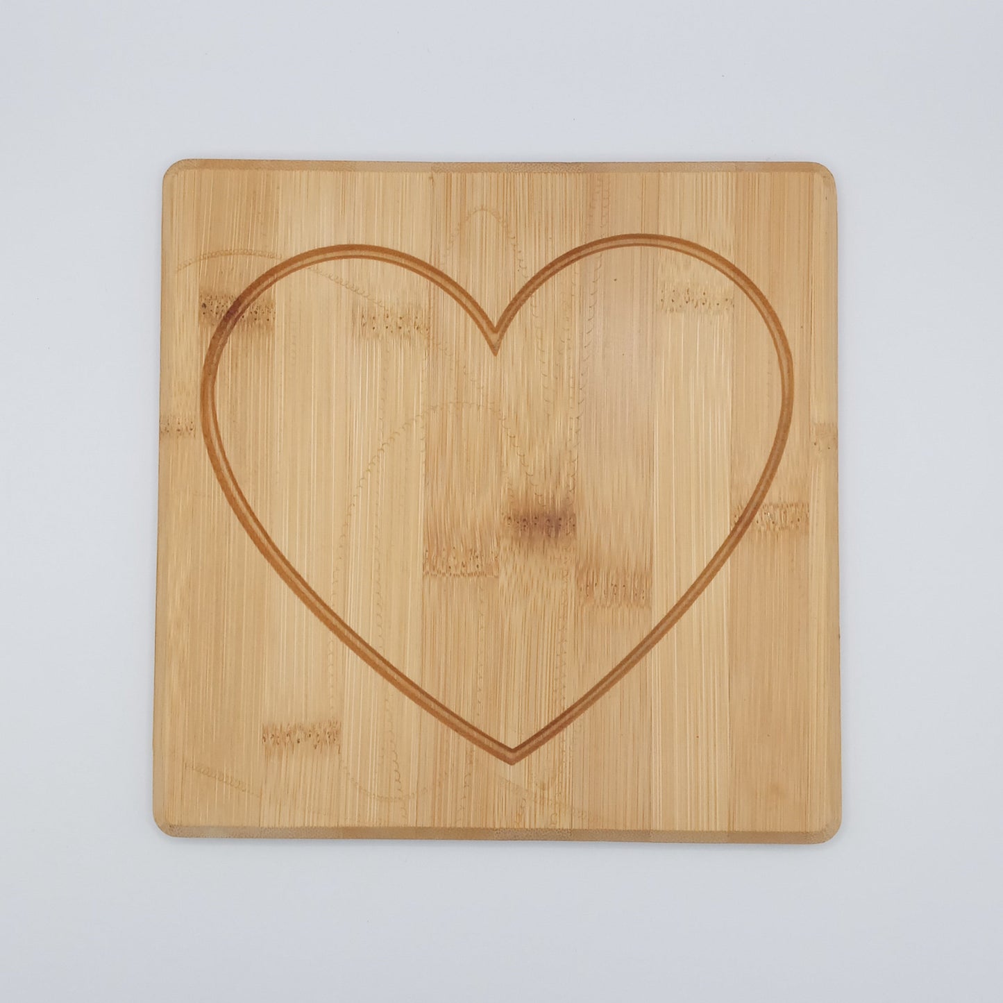 Heart engraved bamboo cutting board