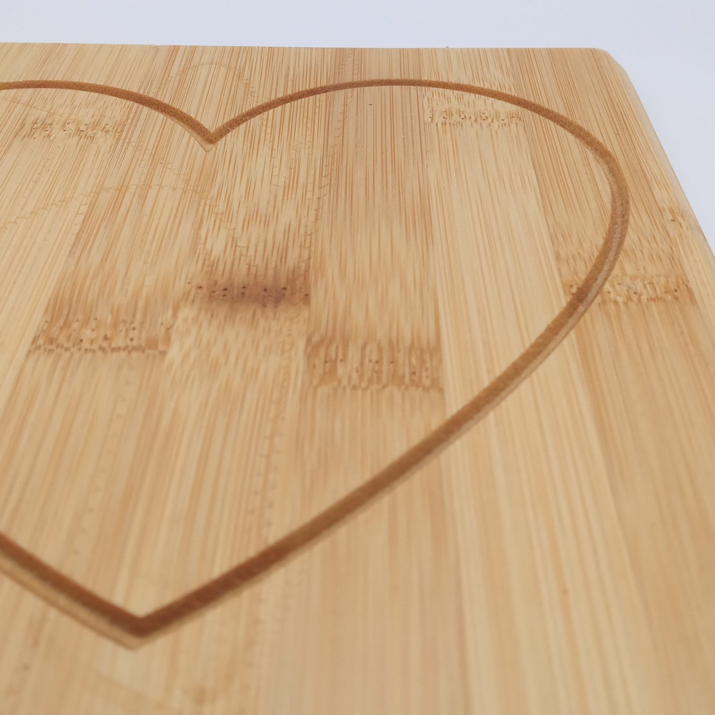 Heart engraved bamboo cutting board